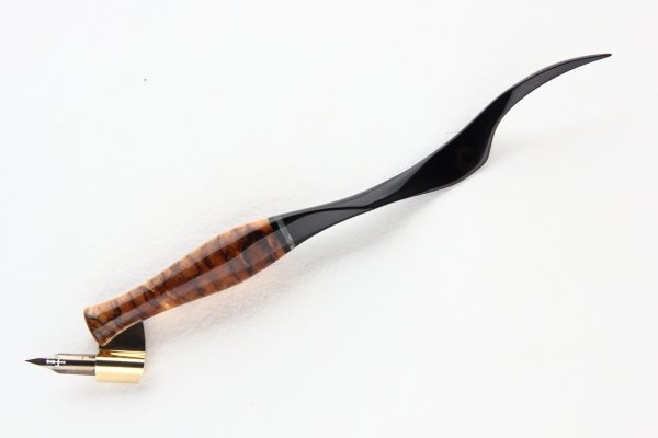 Oblique pen holder with carved tail, made of Stabilized Spalted Carelian Birch and Gabon Ebony, with an insert of Stabilized Maple Burl